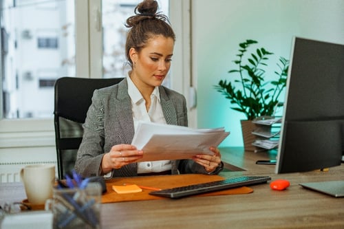 A person sitting at a desk reading papers

AI-generated content may be incorrect.